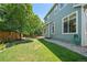 Backyard featuring a well-maintained green lawn and the house's green exterior at 17235 Opal Hill Dr, Parker, CO 80134