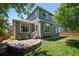 Backyard with a green lawn, a brick patio, and a two-story home with large windows at 17235 Opal Hill Dr, Parker, CO 80134