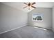 Cozy bedroom featuring vaulted ceilings, a ceiling fan, and a window at 17235 Opal Hill Dr, Parker, CO 80134