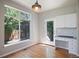 Sunlit breakfast nook with hardwood floors, a large window, and built-in desk area at 17235 Opal Hill Dr, Parker, CO 80134
