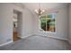 Inviting dining room with a modern chandelier, a large window, and access to the kitchen at 17235 Opal Hill Dr, Parker, CO 80134