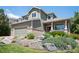 Inviting two-story home showcasing a well-maintained lawn and beautiful rock garden at 17235 Opal Hill Dr, Parker, CO 80134