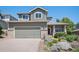 Charming two-story home with a light-green exterior, stone accents, and inviting front porch at 17235 Opal Hill Dr, Parker, CO 80134