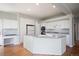Bright kitchen features white cabinets, a large island, and hardwood floors at 17235 Opal Hill Dr, Parker, CO 80134