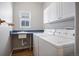 Laundry room with sink, cabinets, window, washer, and dryer at 17235 Opal Hill Dr, Parker, CO 80134