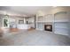 Open-concept living room with fireplace, built-in shelves, and an adjacent kitchen at 17235 Opal Hill Dr, Parker, CO 80134