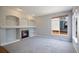 Cozy living room features a fireplace with stone surround and built-in shelving at 17235 Opal Hill Dr, Parker, CO 80134