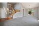 Bright living room featuring vaulted ceilings, large windows, and a staircase leading to the second floor at 17235 Opal Hill Dr, Parker, CO 80134