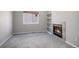Inviting living room with a cozy fireplace, built-in shelving, and soft carpet at 17235 Opal Hill Dr, Parker, CO 80134