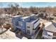 Modern two-story home featuring blue and gray tones with a rooftop deck and manicured backyard, perfect for urban living at 3930 Yates St, Denver, CO 80212