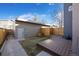 Backyard featuring a wooden deck and convenient access to the garage at 3930 Yates St, Denver, CO 80212