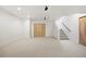 Spacious basement area with plush carpeting, neutral walls, ample storage, and a staircase leading to the upper level at 3930 Yates St, Denver, CO 80212
