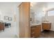 Bright bathroom featuring floating wood vanity and neutral granite counter at 3930 Yates St, Denver, CO 80212