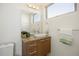 Bathroom featuring wood vanity, granite counter and large mirror at 3930 Yates St, Denver, CO 80212