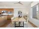 Bright dining room with a modern table, neutral chairs, contemporary light fixture, and a view from a large window at 3930 Yates St, Denver, CO 80212