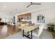 Open-concept dining area with a modern wood table, neutral-toned chairs, stylish decor, and hardwood floors throughout the area at 3930 Yates St, Denver, CO 80212