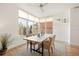 Sunlit dining area featuring a modern table, comfortable seating, neutral rug, and large windows with a scenic view at 3930 Yates St, Denver, CO 80212
