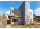 Modern two-story home with gray and neutral siding, large windows, and a well-kept front lawn at 3930 Yates St, Denver, CO 80212