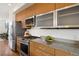 Modern kitchen with stainless steel appliances, granite counters, and wood cabinetry, blending style and functionality at 3930 Yates St, Denver, CO 80212