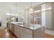 Open kitchen island with barstool seating, stainless steel appliances, and a seamless view into the adjacent living area at 3930 Yates St, Denver, CO 80212