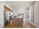 Contemporary kitchen with hardwood floors, stainless steel appliances, and a large island with pendant lighting at 3930 Yates St, Denver, CO 80212