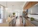 Open kitchen layout featuring modern appliances, sleek cabinets, and a view into the living room at 3930 Yates St, Denver, CO 80212