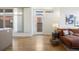 Inviting living room featuring hardwood floors, natural light, stylish furnishings, and seamless access to the outdoor area at 3930 Yates St, Denver, CO 80212