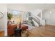 Spacious living room featuring hardwood floors, a modern staircase, and plenty of natural light at 3930 Yates St, Denver, CO 80212