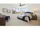 Spacious main bedroom with scenic windows, comfy seating, a patterned quilt, and warm lighting for a relaxing ambiance at 3930 Yates St, Denver, CO 80212