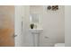 Stylish powder room with a pedestal sink, sleek fixtures, and neutral décor creates a serene and modern space at 3930 Yates St, Denver, CO 80212