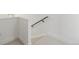 Staircase with off-white carpet and black metal handrail at 3930 Yates St, Denver, CO 80212