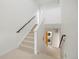 Carpeted staircase leading to second floor and laundry closet at 3930 Yates St, Denver, CO 80212