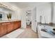 Bright bathroom featuring dual sink vanity, soaking tub, and tiled floors at 10622 Racine St, Commerce City, CO 80022