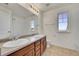 Bathroom with double sink vanity, large mirror and a tiled shower for a luxurious experience at 10622 Racine St, Commerce City, CO 80022