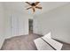 Bedroom featuring a ceiling fan, neutral carpet, and a closet at 10622 Racine St, Commerce City, CO 80022