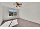 Bedroom featuring a ceiling fan, neutral carpet, and ample natural light at 10622 Racine St, Commerce City, CO 80022