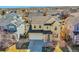 Aerial view of a charming yellow two-story home with well-maintained landscaping at 10622 Racine St, Commerce City, CO 80022