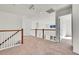 Bright upstairs hallway features neutral carpet, white walls and railings, and wooden trim at 10622 Racine St, Commerce City, CO 80022