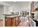 Open kitchen with a view of the dining area, wood cabinets, and tile backsplash at 10622 Racine St, Commerce City, CO 80022