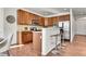 Well-lit kitchen with stainless steel appliances, hardwood floors, and a breakfast bar at 10622 Racine St, Commerce City, CO 80022