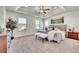 Spacious main bedroom suite features a trey ceiling, ceiling fan, and plenty of natural light at 10622 Racine St, Commerce City, CO 80022