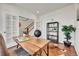 Bright home office with french doors, hardwood floors, a desk and decorative shelving at 10622 Racine St, Commerce City, CO 80022