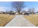 Neighborhood park featuring benches and a paved walking path surrounded by green spaces at 10622 Racine St, Commerce City, CO 80022