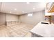 Finished basement showcasing a bar area with stylish countertops and cabinets at 1302 S Cape Way, Lakewood, CO 80232