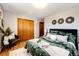 Cozy bedroom featuring hardwood floors and closet, with stylish decor at 1302 S Cape Way, Lakewood, CO 80232