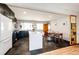 Modern kitchen with white countertops, dark cabinets, and stainless steel appliances adjacent to dining area at 1302 S Cape Way, Lakewood, CO 80232