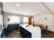 Modern kitchen featuring white countertops, stainless steel appliances, and adjacent dining area at 1302 S Cape Way, Lakewood, CO 80232