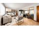 Modern living room open to kitchen featuring stylish furniture and hardwood flooring at 1302 S Cape Way, Lakewood, CO 80232