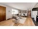 Cozy living room features hardwood flooring, and neutral paint scheme at 1302 S Cape Way, Lakewood, CO 80232