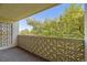 Balcony with decorative block walls, view of trees and blue sky at 3184 S Heather Gardens Way # 302, Aurora, CO 80014